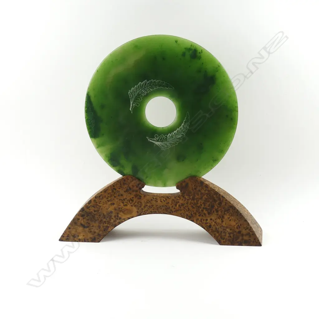 A pounamu bi disc on burr totara stand Image 1++
