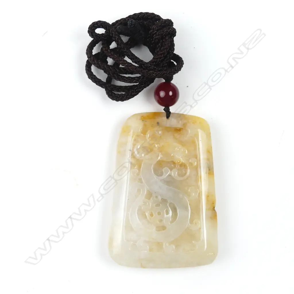 A Chinese egg yolk and pale toned carved tablet pendant Image 1++