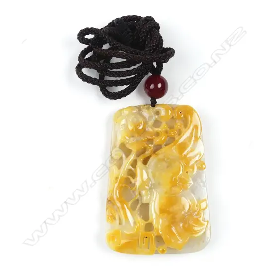 A Chinese egg yolk and pale toned carved tablet pendant