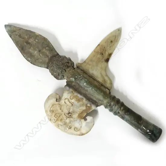 A metal and stone replica of an archaic Chinese halberd head