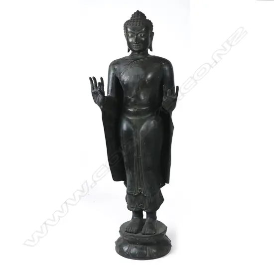 A large Eastern bronze standing Buddha figure