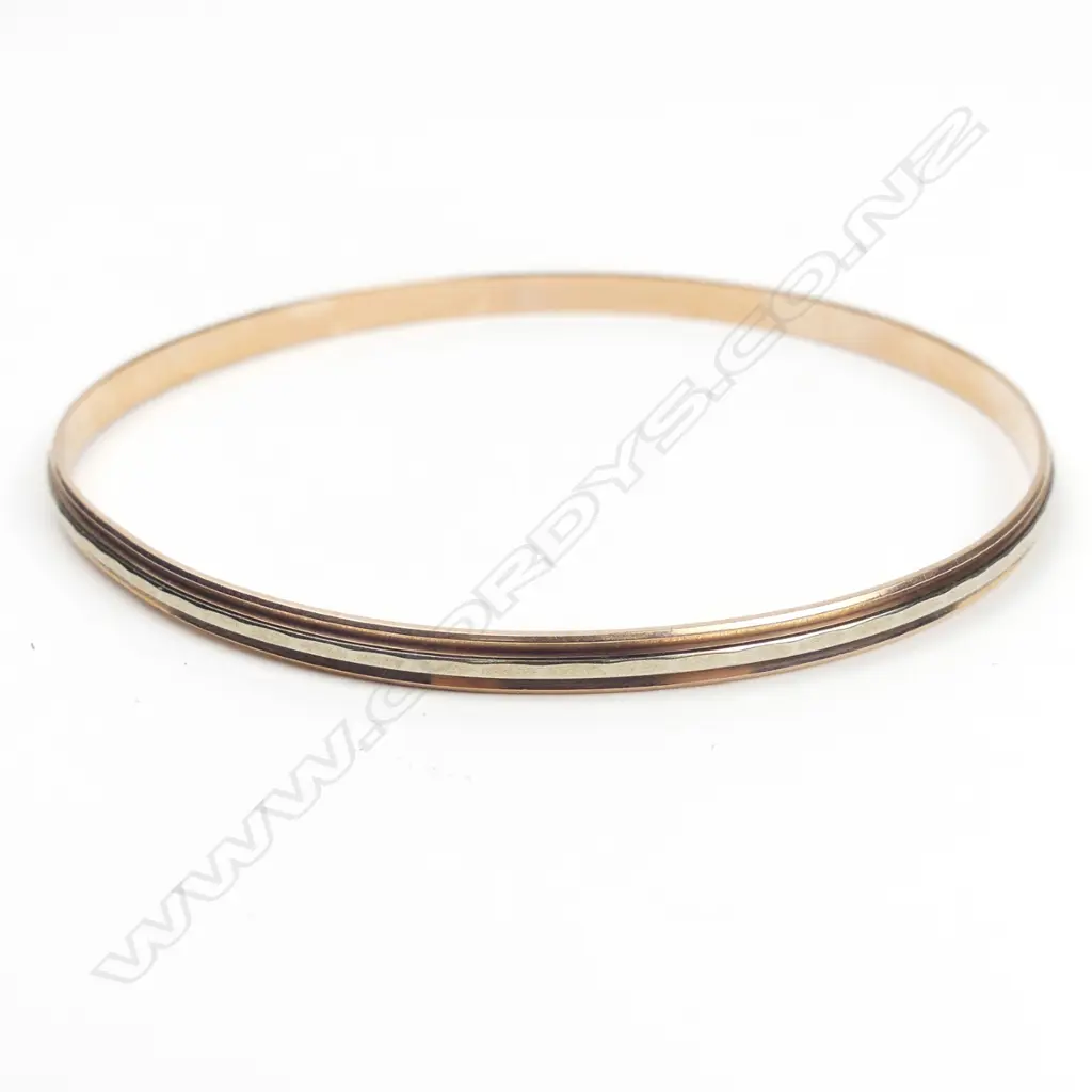 An 8ct rose and white gold bangle Image 1++