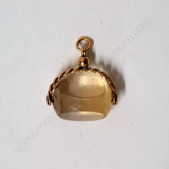An early 20thC 9ct. yellow gold and citrine fob spinner