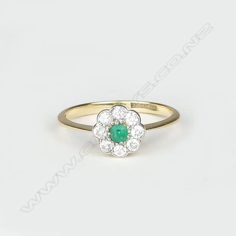 An 18ct gold emerald and diamond cluster ring Image 1++