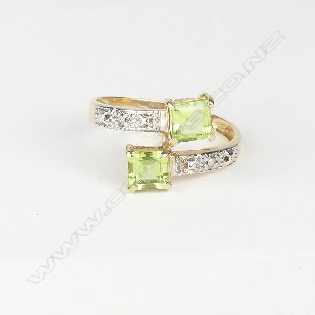 A 10ct. yellow gold peridot and diamond ring Image 1++