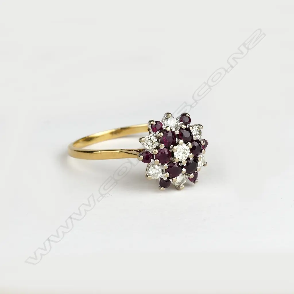 An 18ct. gold ruby and diamond cluster ring Image 1++