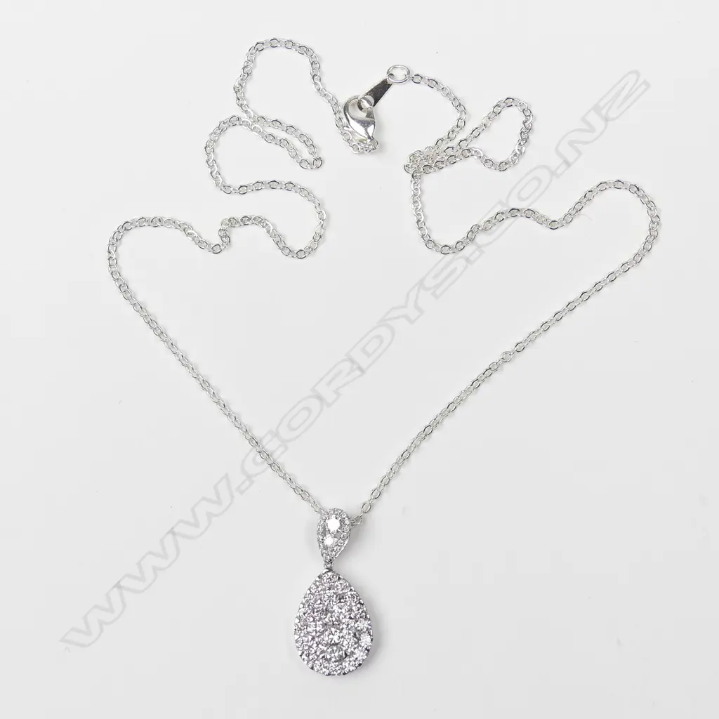 An 18ct. white gold and diamond pendant on chain Image 1++