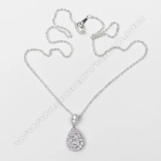 An 18ct. white gold and diamond pendant on chain