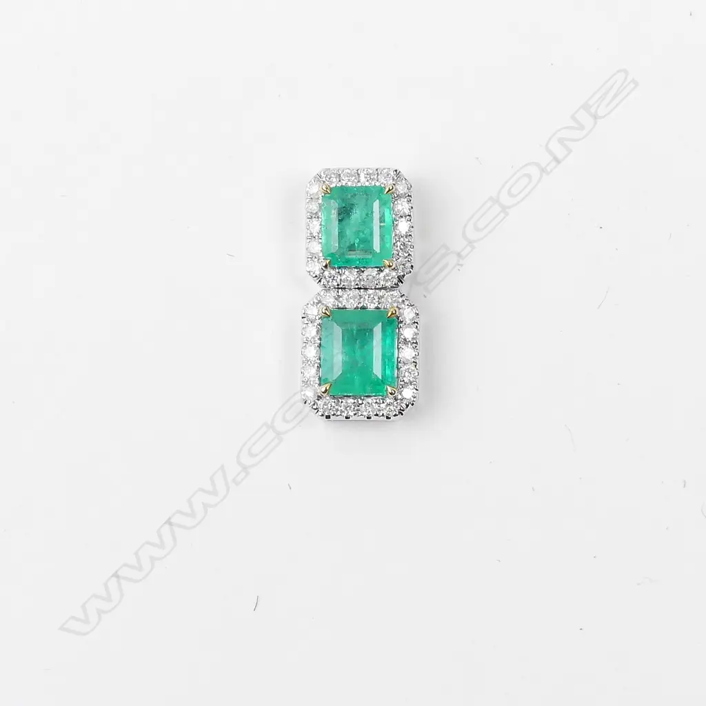 An 18ct white gold emerald and diamond pendant Image 1++