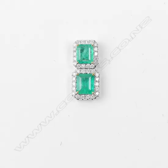 An 18ct white gold emerald and diamond pendant
