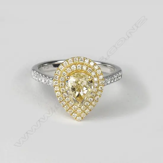 A lady's modern 18ct. white and yellow gold 1.44ct. yellow diamond and cluster ring