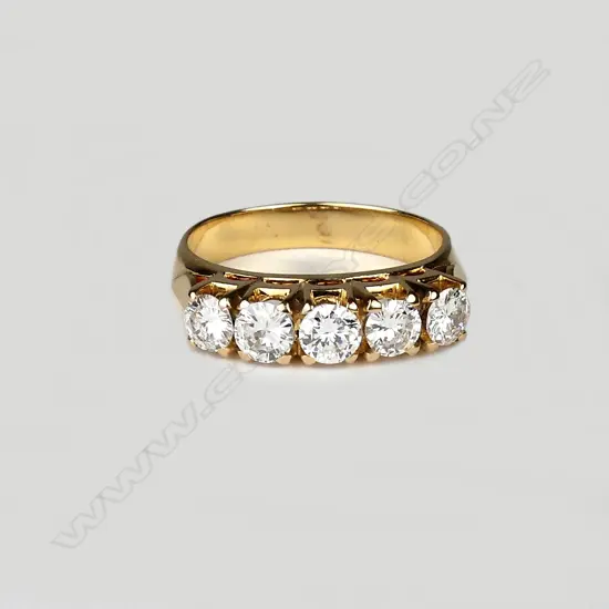 A 19ct gold and five stone diamond ring