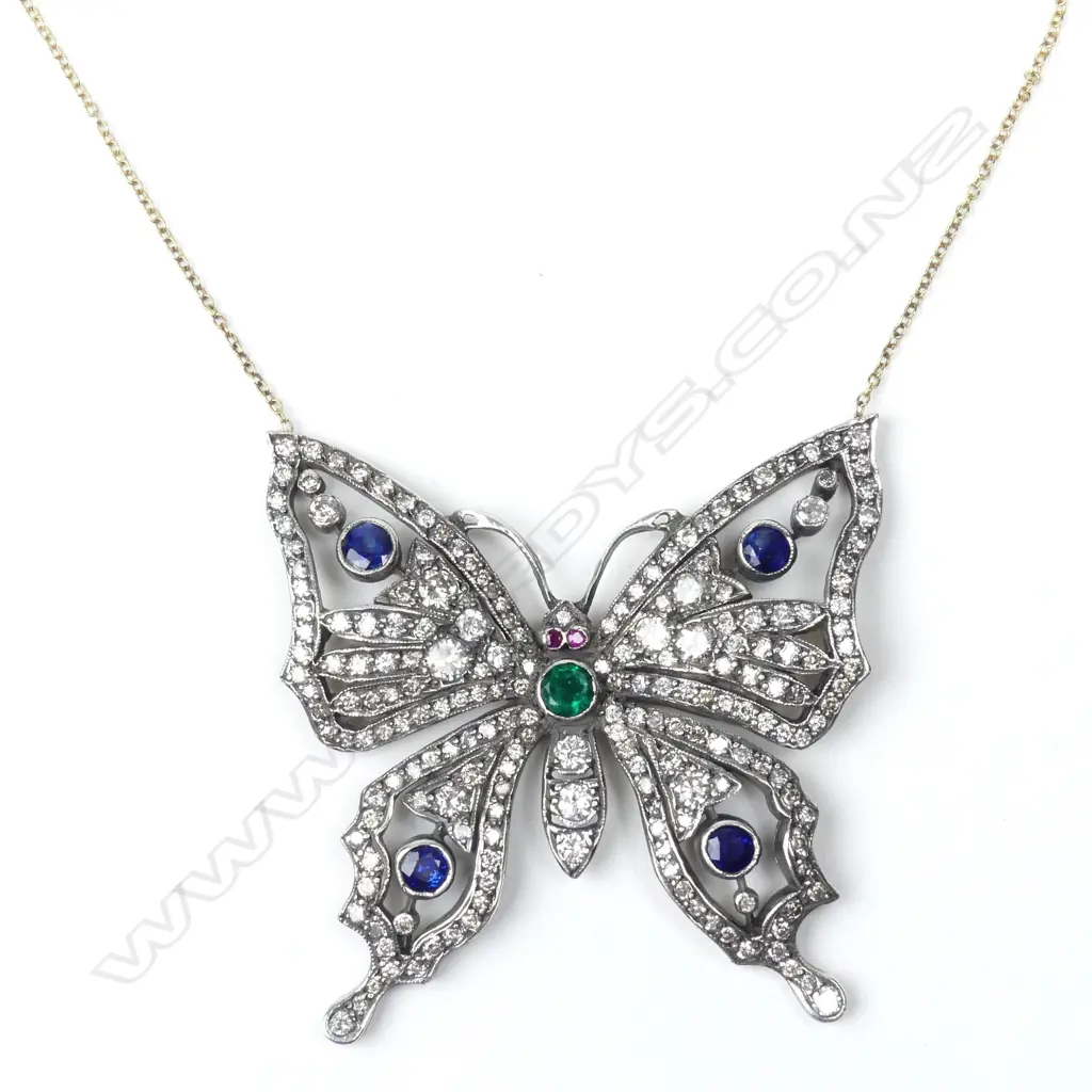 A gold and silver diamond encrusted butterfly pendant Image 1++