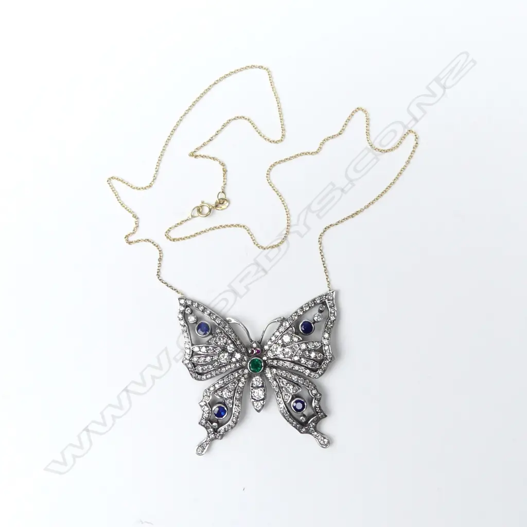 A gold and silver diamond encrusted butterfly pendant Image 1++