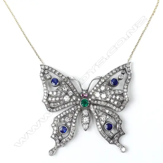 A gold and silver diamond encrusted butterfly pendant