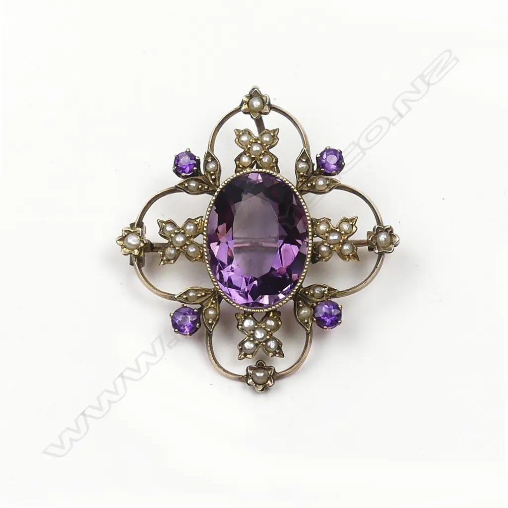 An early 20thC 9ct. gold amethyst and seed pearl decorative brooch Image 1++