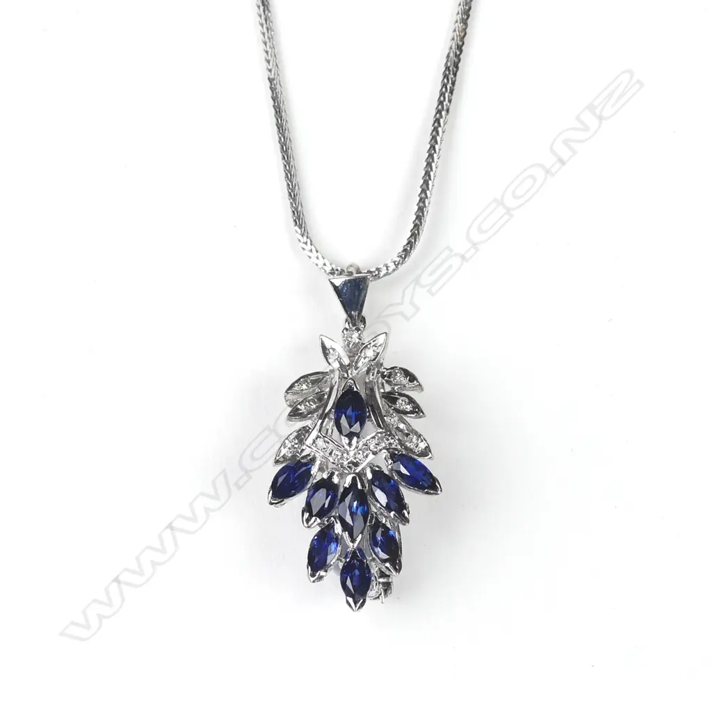 A 9ct white gold sapphire and diamond pendant/brooch on 18ct white gold chain Image 1++