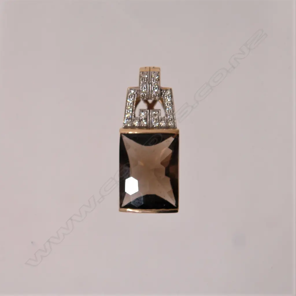 A 9ct. gold mounted stylish topaz and diamond pendant Image 1++
