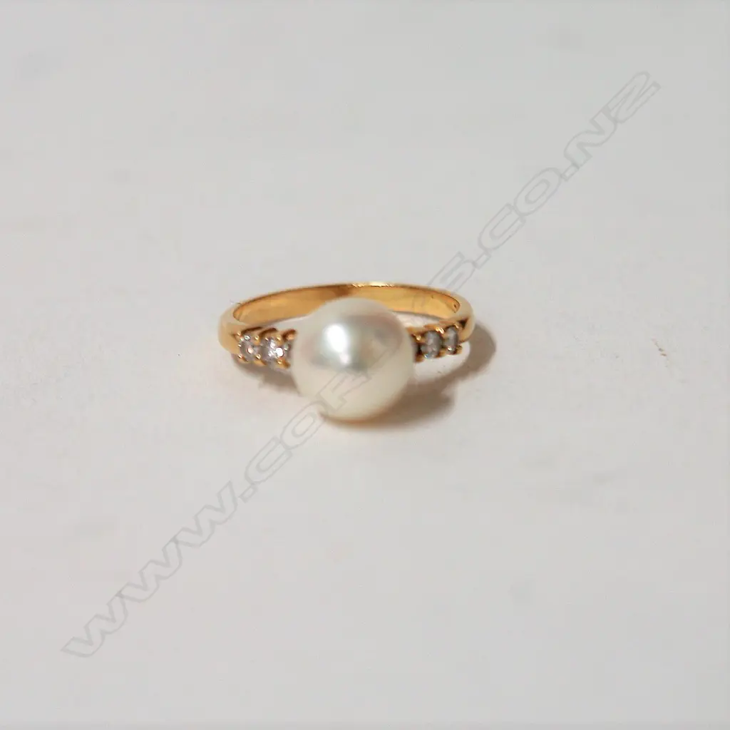 An 18ct. yellow gold cultured pearl and diamond dress ring Image 1++