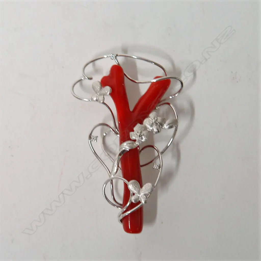 A modern 18ct. white gold red coral and diamond art form brooch Image 1++