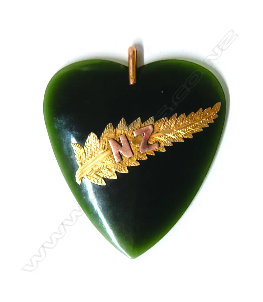 A good early 20thC greenstone heart and gold mounted pendant Image 1++