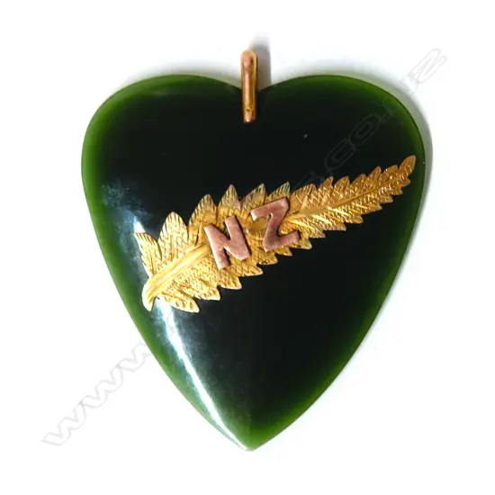A good early 20thC greenstone heart and gold mounted pendant