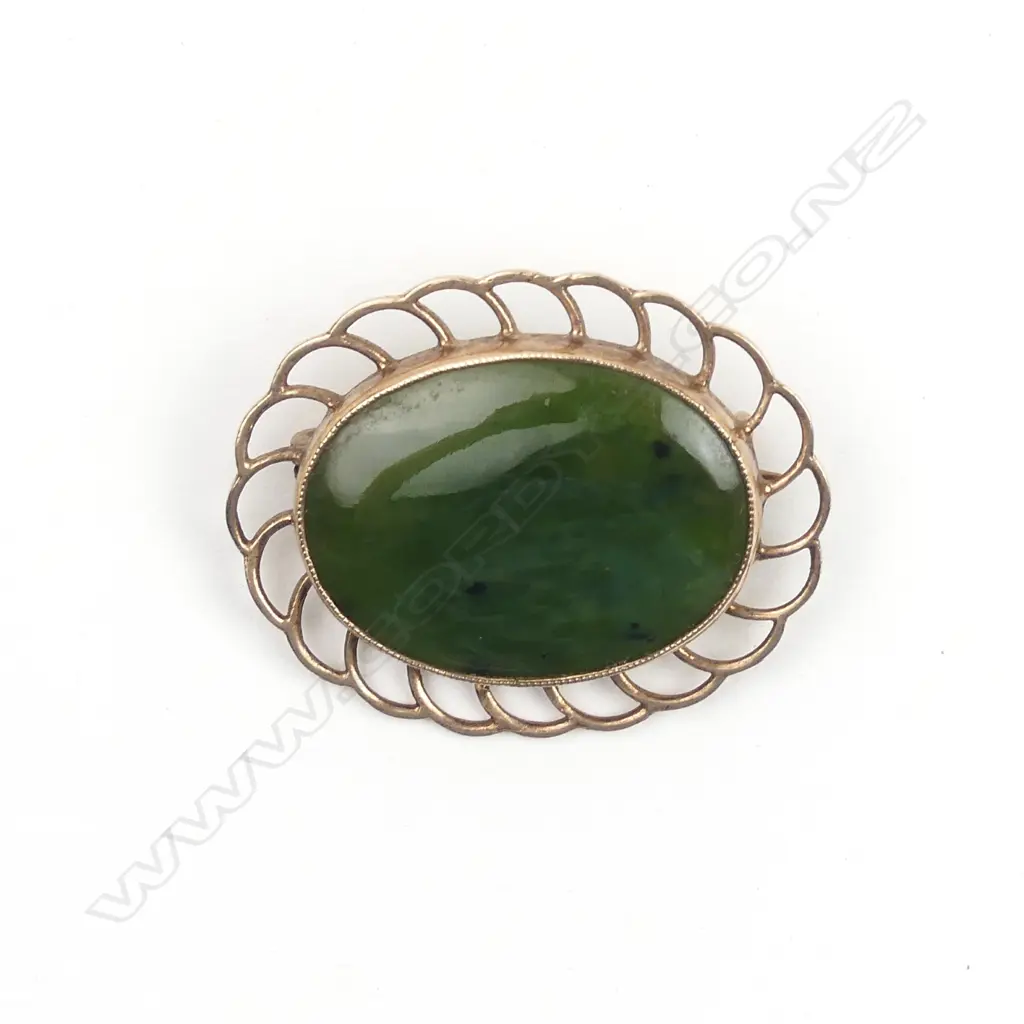 A 9ct. rose gold framed greenstone brooch Image 1++