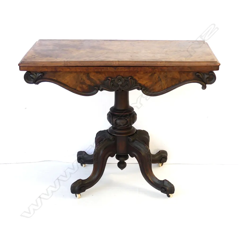 A Victorian walnut fold-over top games table Image 1++