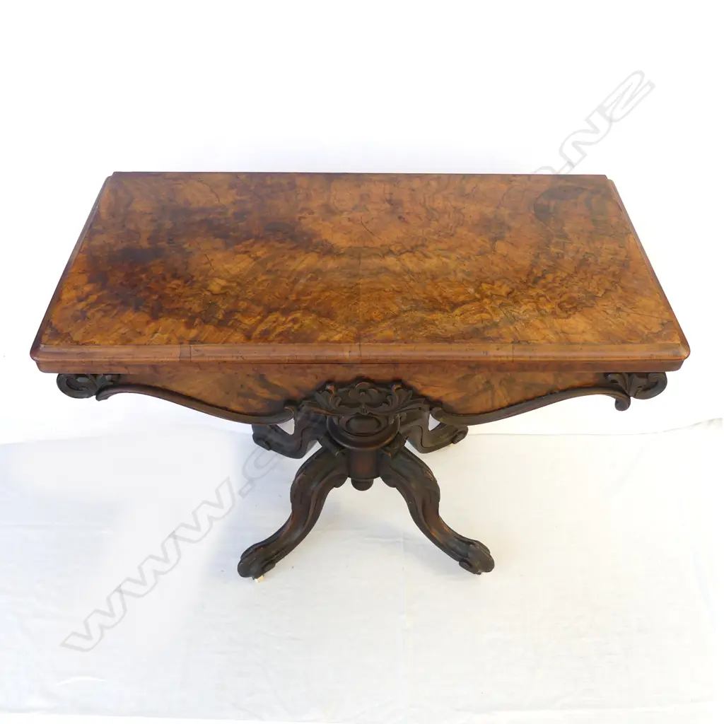 A Victorian walnut fold-over top games table Image 1++