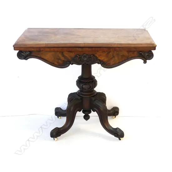 A Victorian walnut fold-over top games table