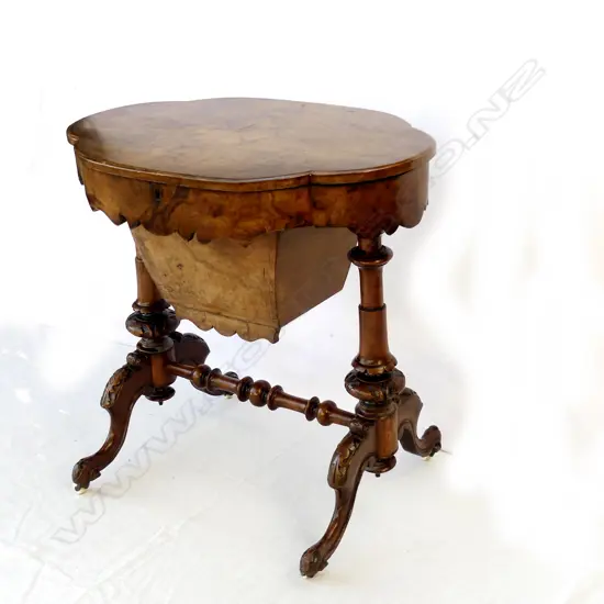 A Victorian figured walnut sewing table