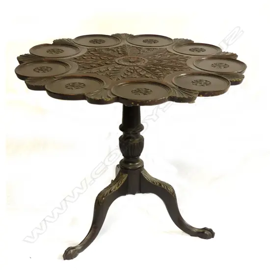 A Georgian mahogany tilt-top carved supper table