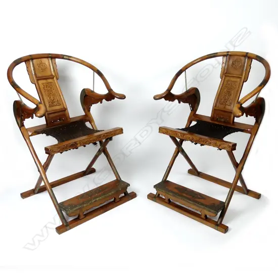 A pair of Chinese hardwood horseshoe-back folding armchairs