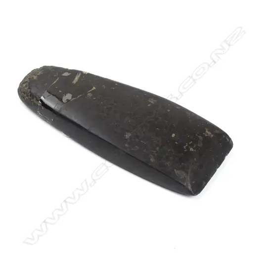 A conglomerate stone adze blade