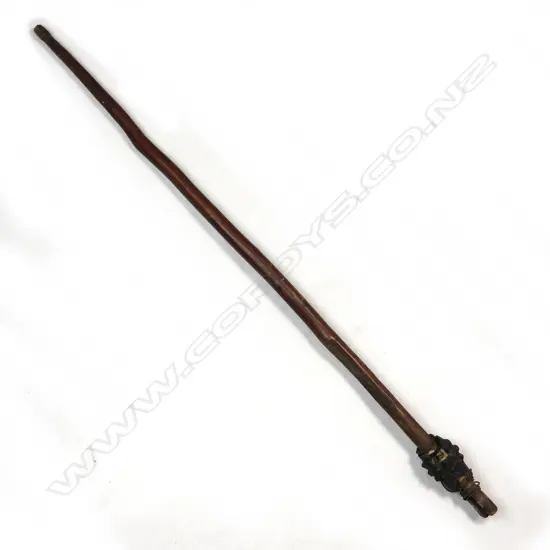 A New Guinea club with carved stone pineapple head