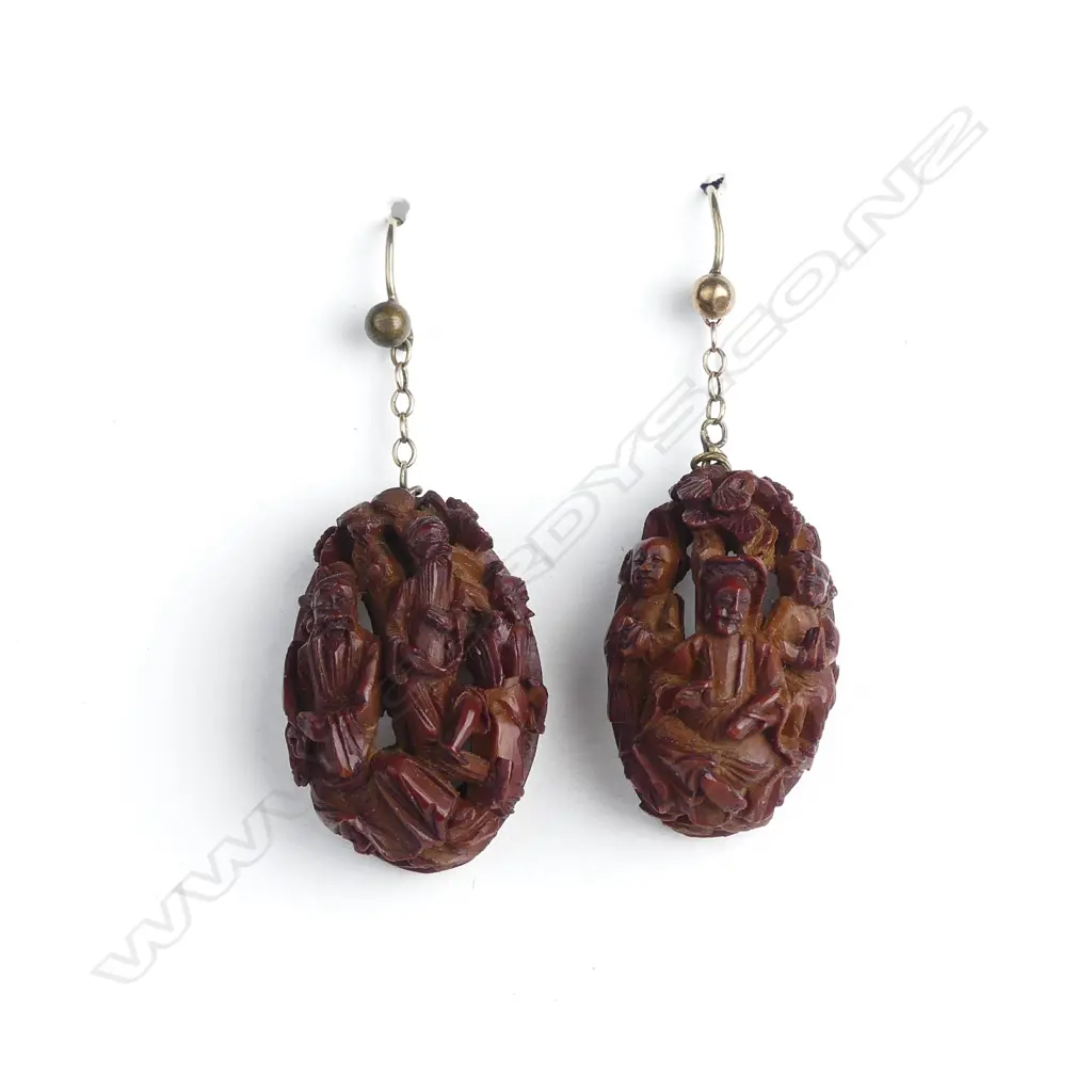A pair of Chinese carved half nut earrings Image 1++