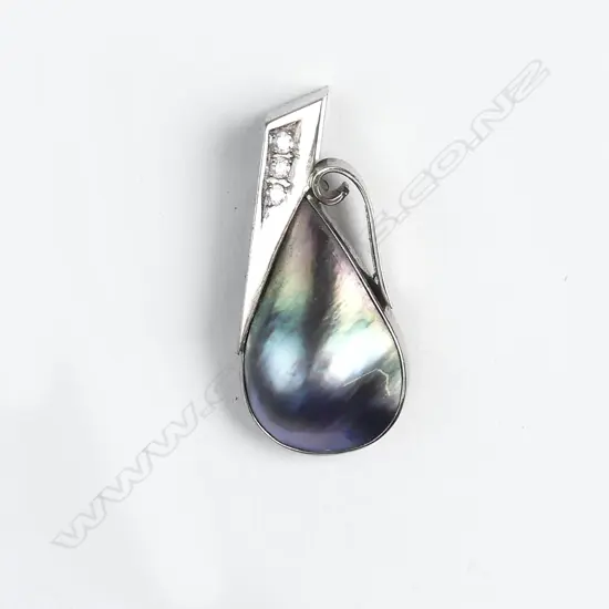An 18ct white gold black pearl and diamond pendant