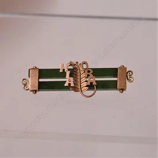 A N.Z. made Harrop & Neill 9ct. rose gold and double greenstone bar brooch