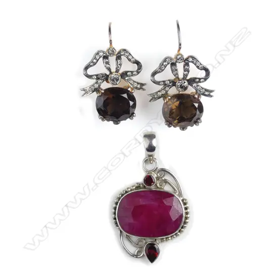 A pair of silver gilt and topaz Belle Epoque earrings and a silver and ruby pendant