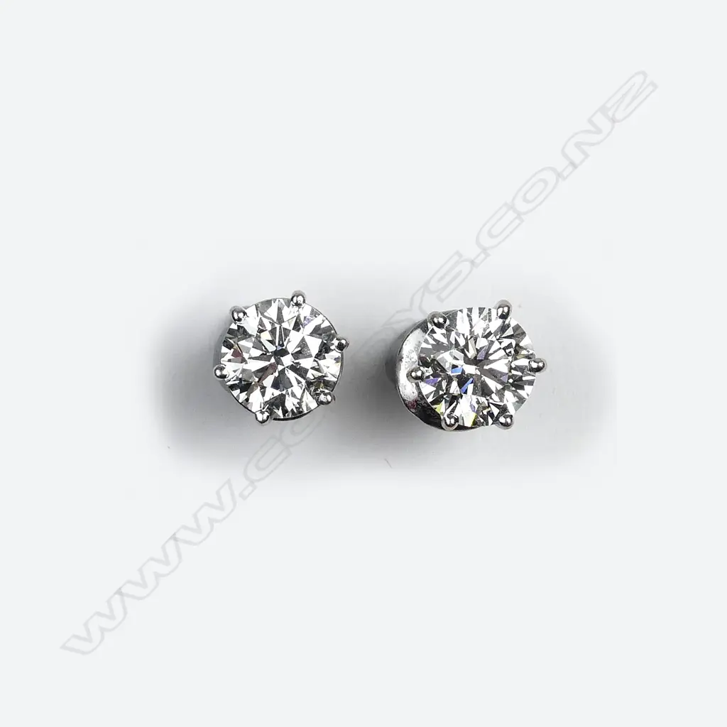 A pair of large and impressive diamond solitaire stud earrings Image 1++