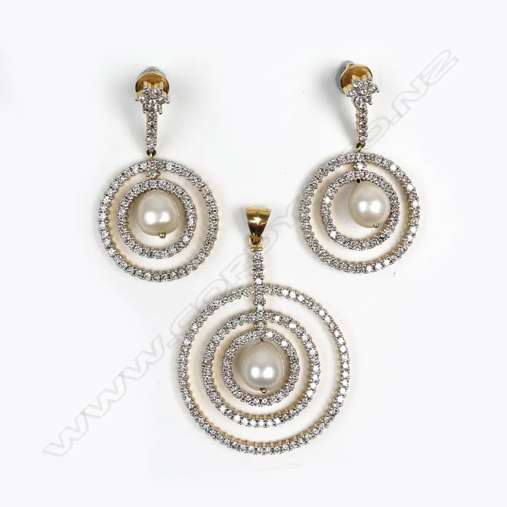 An 18ct gold diamond and pearl pendant and matching earrings Image 1++