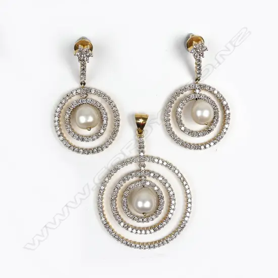 An 18ct gold diamond and pearl pendant and matching earrings