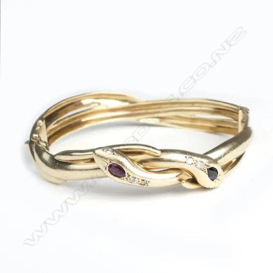 An uncommon vintage heavy 9ct. rose gold double snake hinged bangle