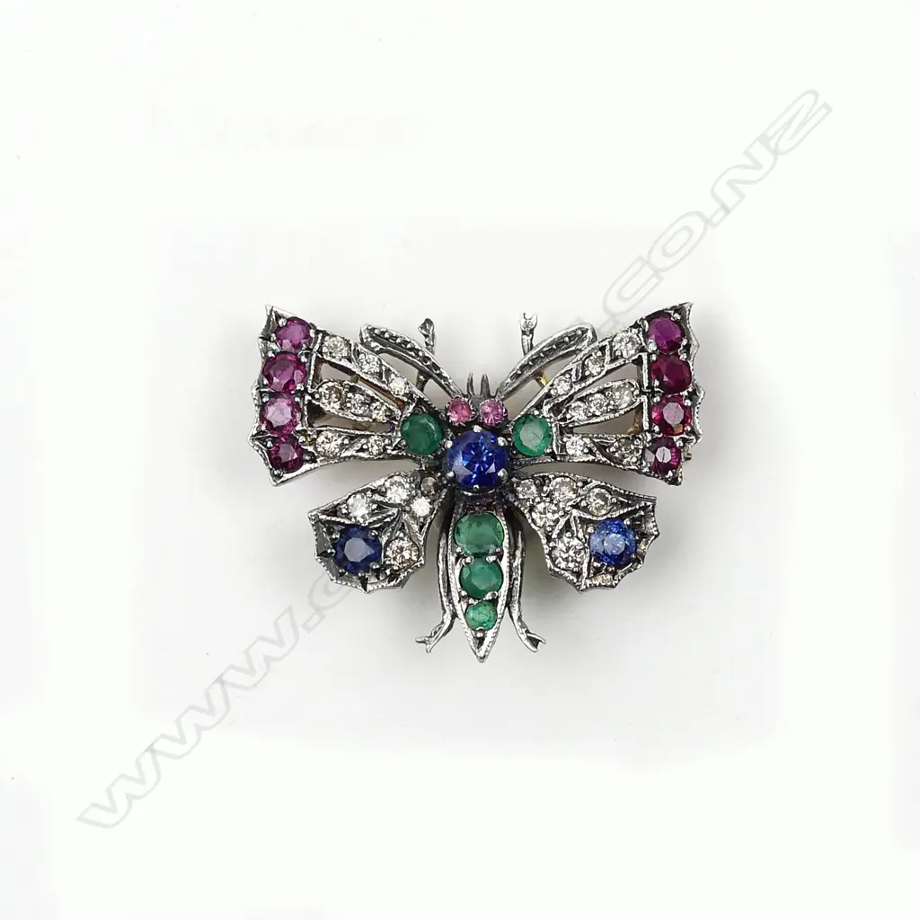 A multi-coloured gemstone encrusted butterfly brooch Image 1++