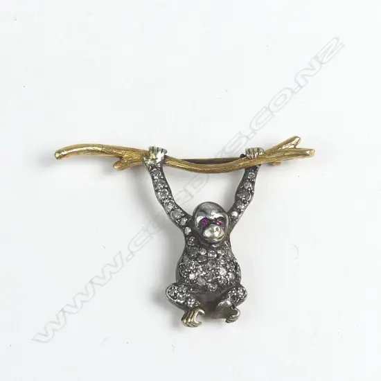 A gold and silver diamond monkey brooch