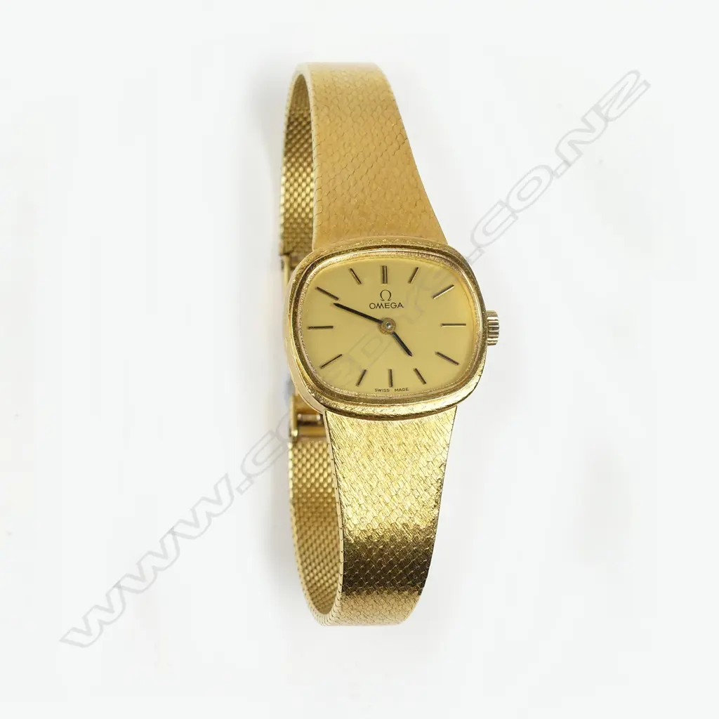 An 18K gold Omega lady's wristwatch with 18K integral mesh bracelet Image 1++
