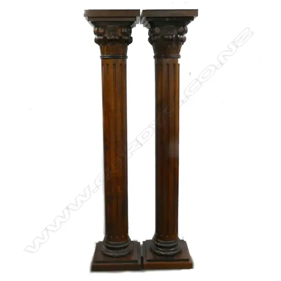 A pair of tall oak Corinthian columns