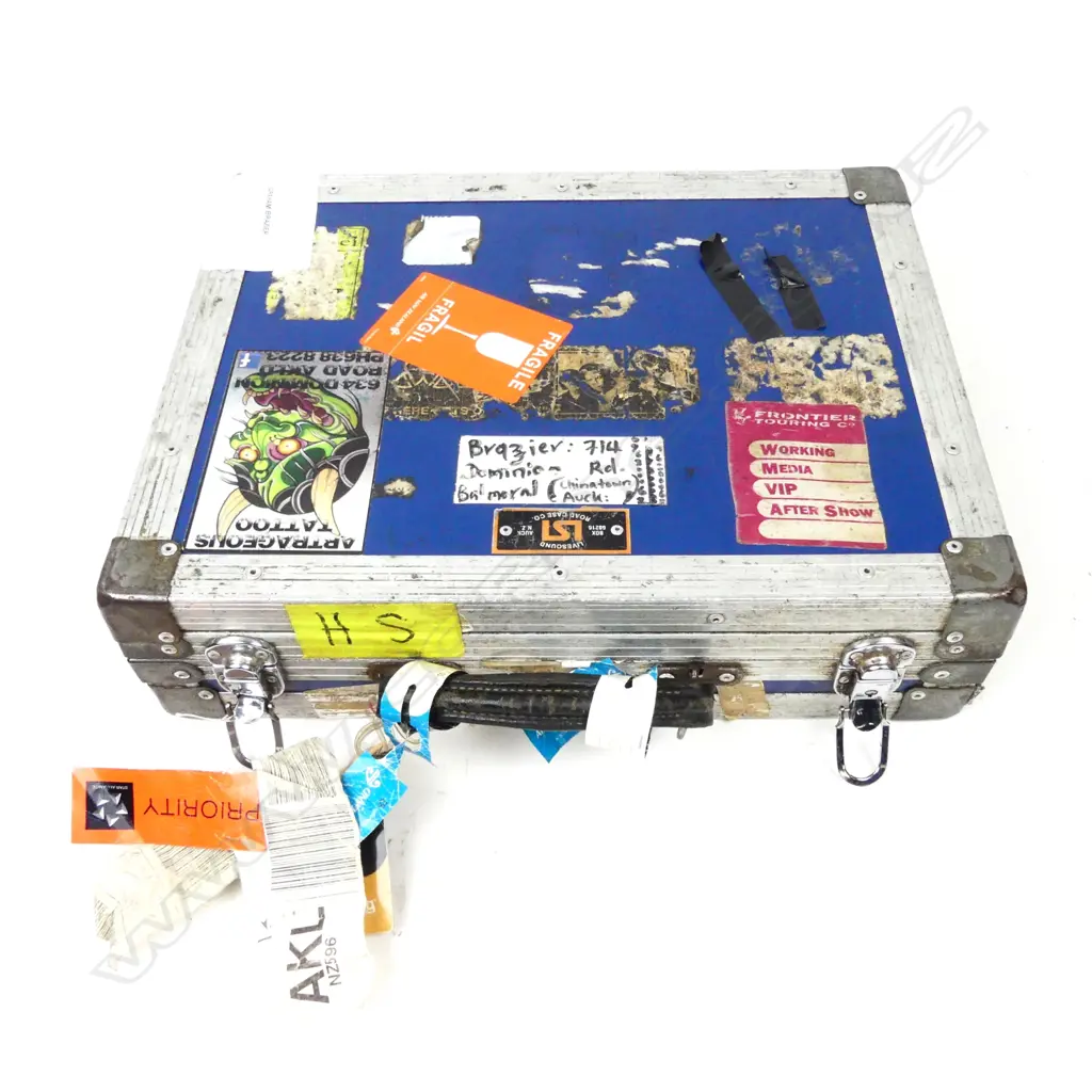 A well-worn road briefcase with approximately 27 assorted harmonicas Image 1++