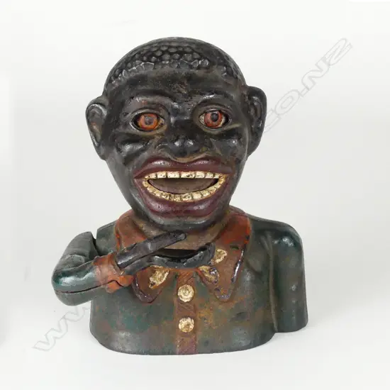 A cast iron 'Greedy Boy' money bank