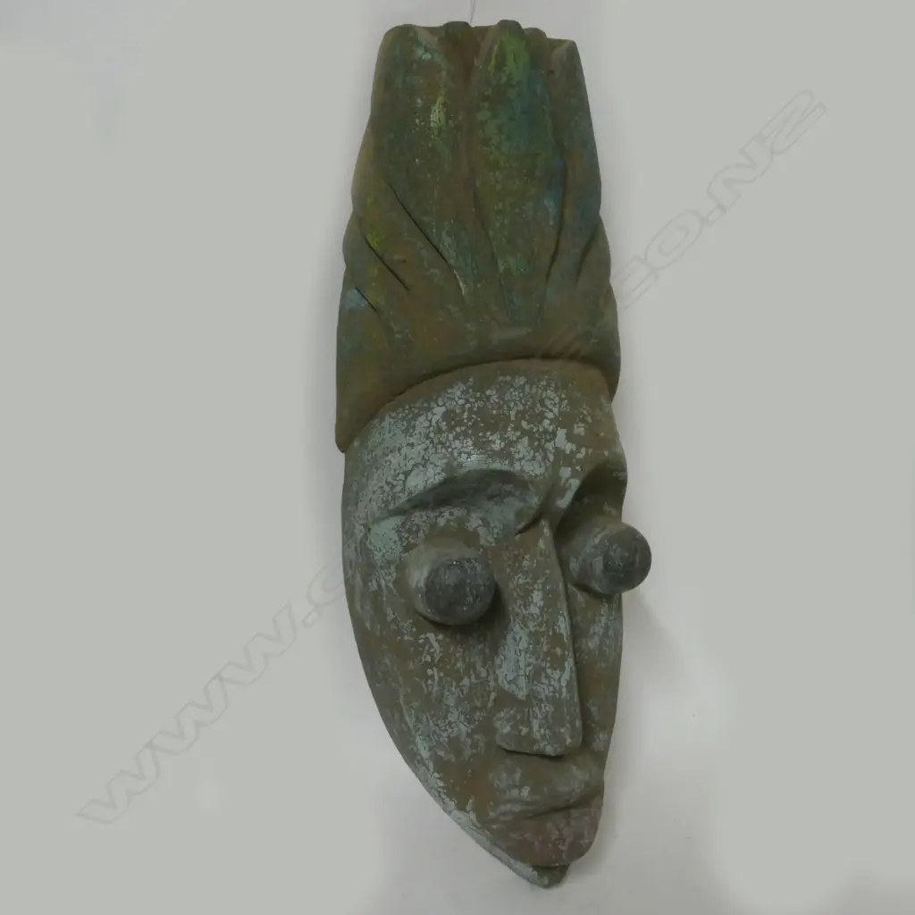 A carved wooden tribal mask Image 1++